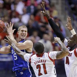 Duke forward Mason Plumlee (5) tries to pass the ball against Louisville forward Chane Behanan (21) and center Gorgui Dieng (10) during the first half of the Midwest Regional final in the NCAA college basketball tournament, Sunday, March 31, 2013, in Indianapolis. 