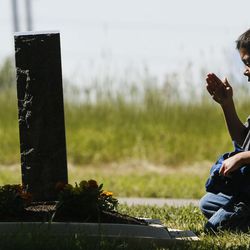 Xavier Deihl, 5, the son of a Marine Corps League member,  salutes a grave in honor for those who have served in the military at Mt. Olivet Cemetery in Salt Lake City on Saturday, May 28, 2016.