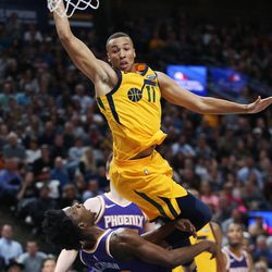 Utah Jazz guard Dante Exum (11) drives and falls on Phoenix Suns guard Josh Jackson (20) in Salt Lake City on Thursday, March 15, 2018. The Jazz 116-88. Exum was called for the offensive foul.
