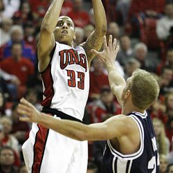 UNLV's Tre'Von Willis shoots over BYU's Tyler Haws during an NCAA college basketball game in Las Vegas on Saturday.