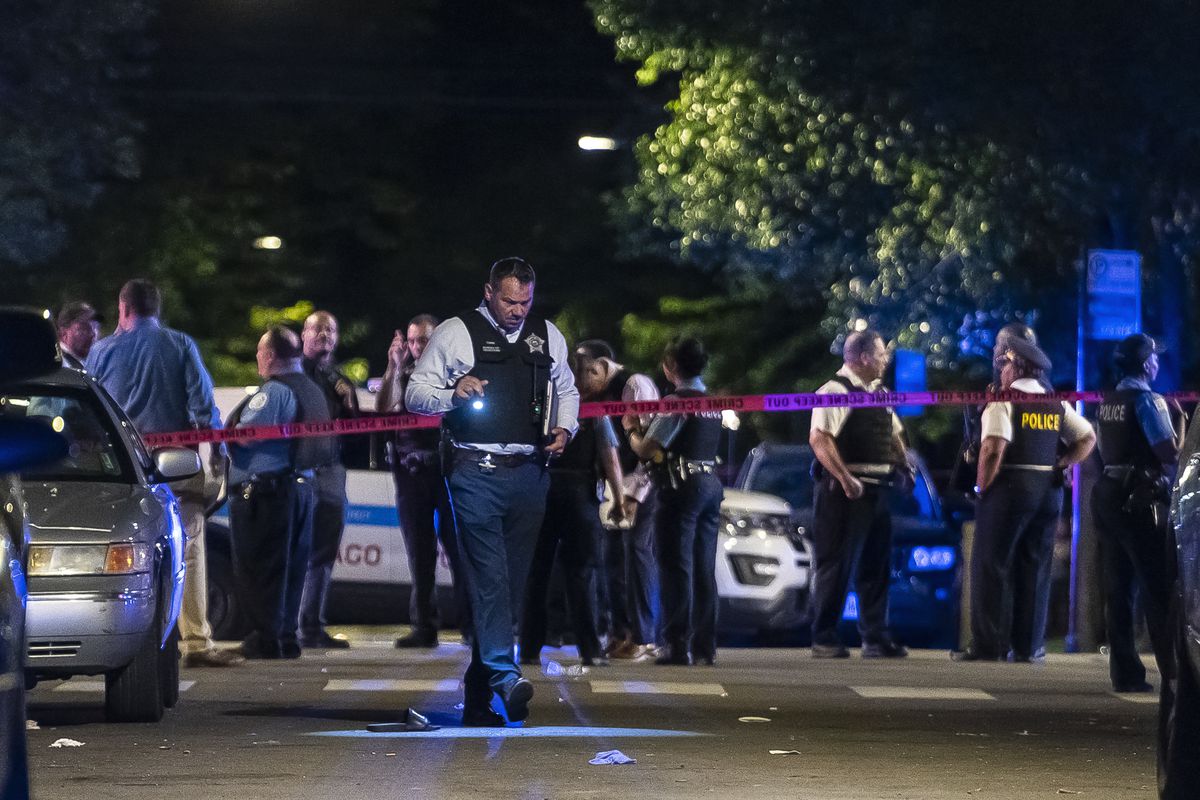 Chicago police investigate a mass shooting that killed Nyoka Bowie, 37, and wounded 10 other people in the 6300 block of South Artesian Avenue in Marquette Park, Sunday night, June 27, 2021. Less than two hours earlier in South Shore, another shooting left 23-year-old Kristina Grimes dead and five other people wounded.