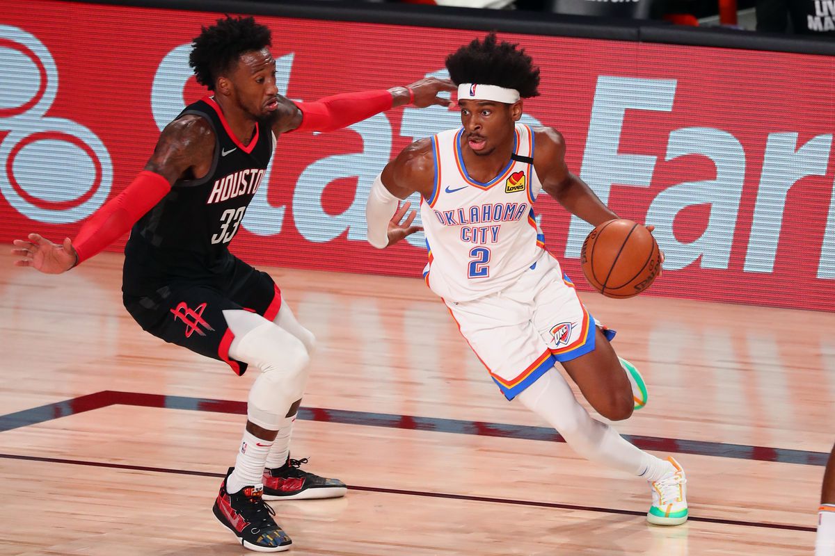 Oklahoma City Thunder guard Shai Gilgeous-Alexander (2) drives against Houston Rockets forward Robert Covington (33) during the first half in game four of the first round of the 2020 NBA Playoffs at AdventHealth Arena.