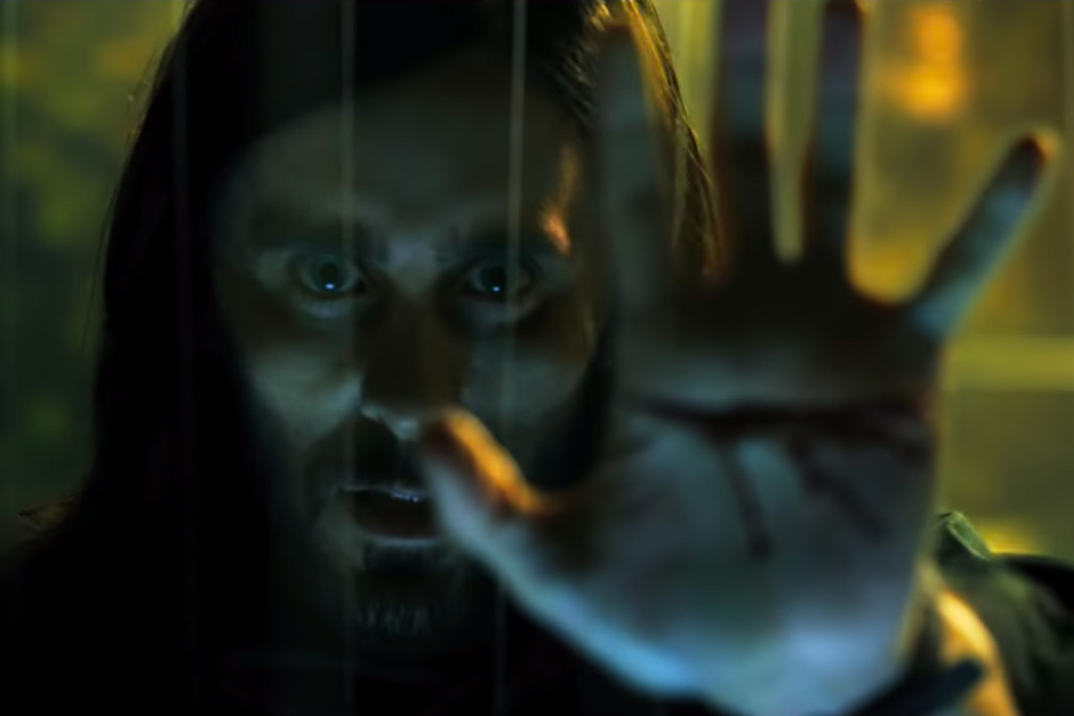 Jared Leto as Michael Morbius holding up his sliced-open hand in Morbius