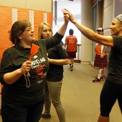Volunteer Charlene Hunt, left, high fives a participant during the Outclimb Cancer Challenge at the Wells Fargo Building in Salt Lake City, Saturday, March 5, 2016. The challenge of climbing the building's 24 floors is a fundraiser for the Huntsman Cancer Institute.