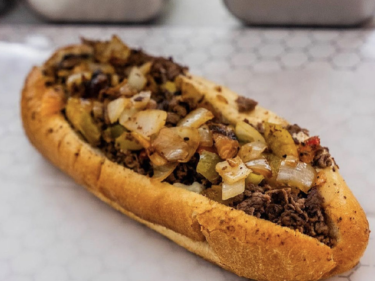 Cheesesteak topped with grilled onions.