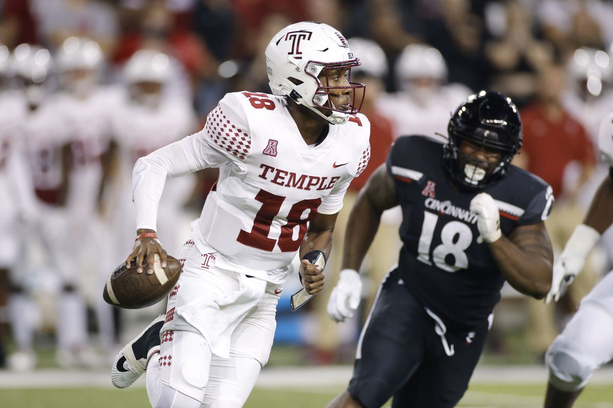 Temple Owls quarterback D’Wan Mathis looks to pass the ball while under pressure from Cincinnati Bearcats defensive lineman Jowon Briggs during a college football game on Oct. 8, 2021 at Nippert Stadium in Cincinnati, Ohio.