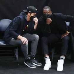 Utah Jazz owner Ryan Smith, left, and Dwayne Wade, who bought a share of the team, talk during a game at the Vivint Arena in Salt Lake City on Friday, April 16, 2021.