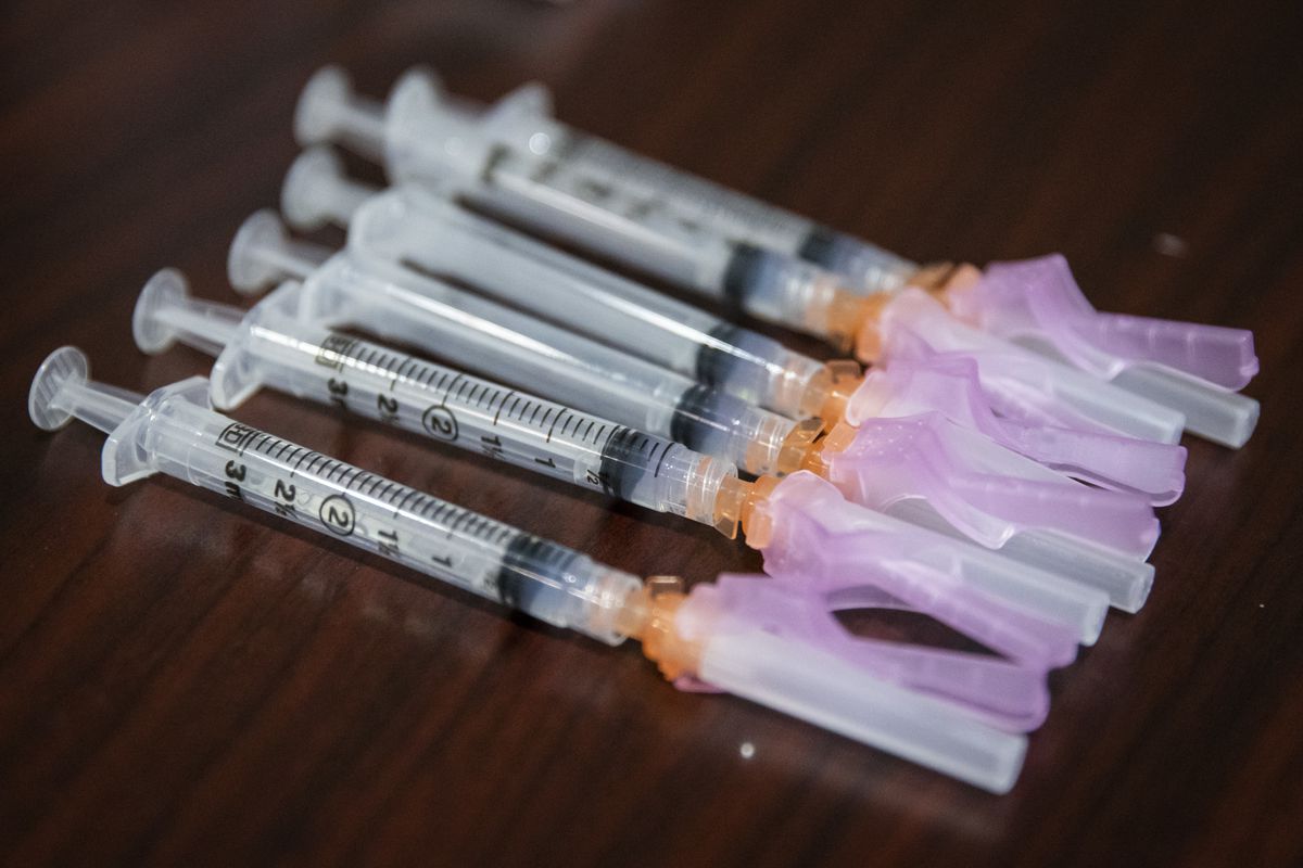 COVID-19 vaccine doses are prepared earlier this year at Weiss Memorial Hospital on the North Side. About half of all Illinois adults are fully vaccinated. 