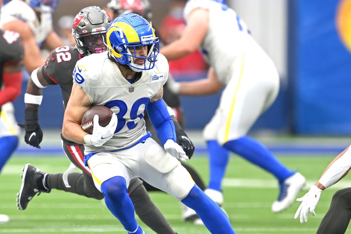Los Angeles Rams tight end Tyler Higbee (89) runs for a first down before he is stopped by Tampa Bay Buccaneers safety Antoine Winfield Jr. (31) in the first half of the game at SoFi Stadium.
