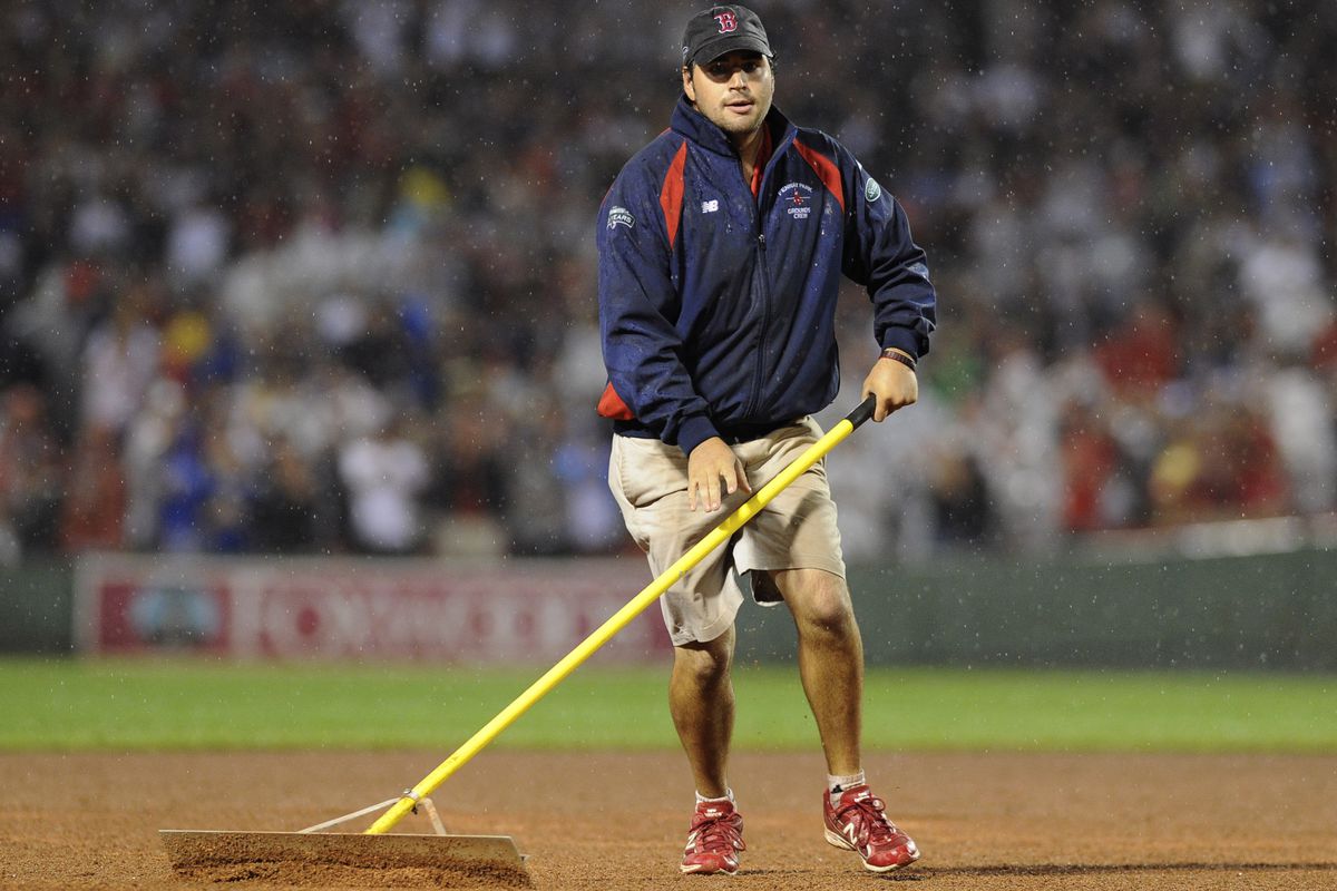 July 31, 2012; Boston, MA, USA; A member of the Boston Red Sox ground crew rakes the field during the fourth inning in a game against the Detroit Tigers at Fenway Park. Mandatory Credit: Bob DeChiara-US PRESSWIRE
