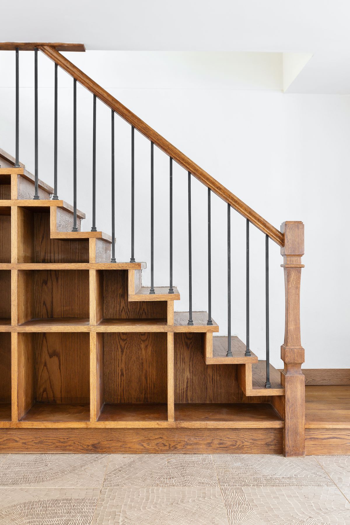 A staircase with shelves built into the side. 