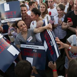 A woman hands out campaign signs at a primary election night party for Mitt Romney in Orem on Tuesday, June 26, 2018. Romney beat state Rep. Mike Kennedy, R-Alpine, for the GOP nomination.