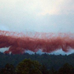 A DC-10 Air Tanker drops fire retardant near home in the evening as the Black Forest Fire continues to burn out of control for a second straight day near Colorado Springs on Wednesday, June 12, 2013. The fire has consumed 11,500 acres. It has destroyed 92 homes and damaged others. The erratic fire has forced the evacuation of thousands of people.  