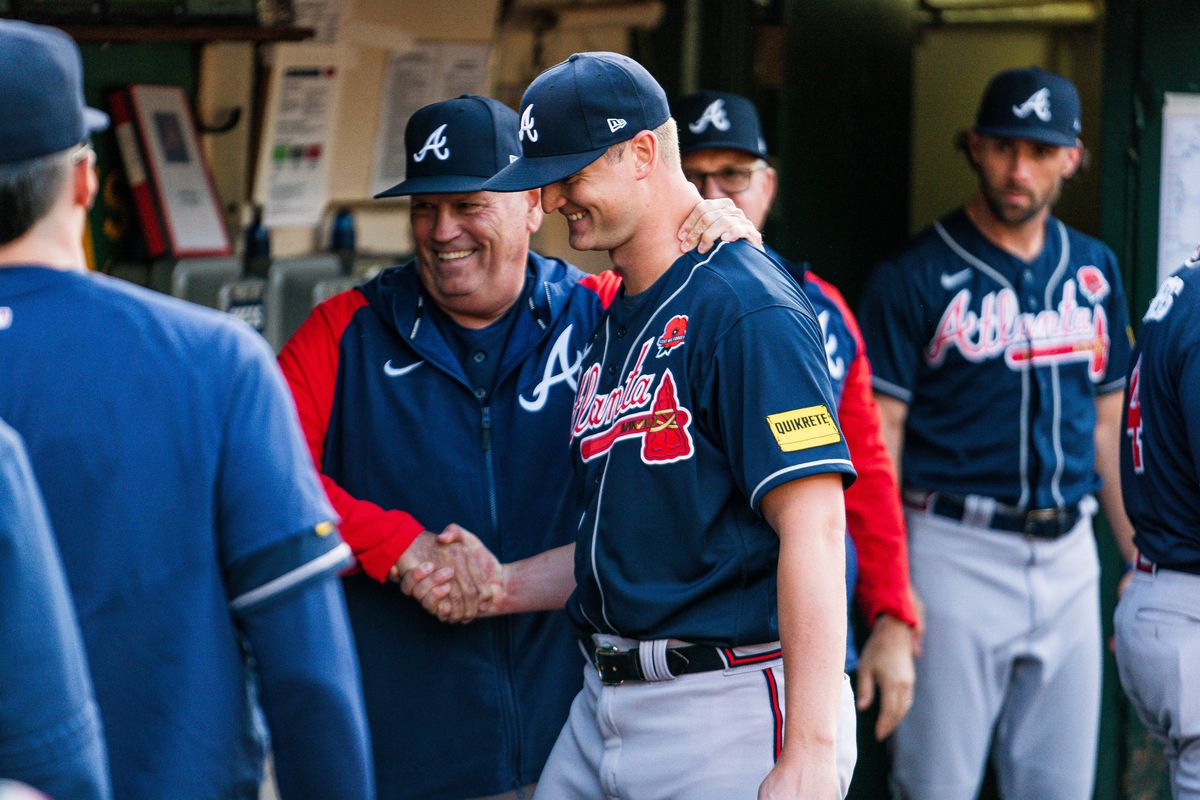 Michael Soroka of the Atlanta Braves is congratulated by Brian Snitker  after leaving the game against the Oakland Athletics after six innings at RingCentral Coliseum on May 29, 2023 in Atlanta, Georgia. It was his first start since 2020 when he tore his achilles tendon.  