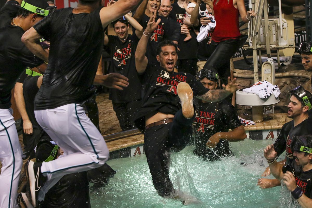 Mike Hazen jumps in the pool when wild card berth was clinched.