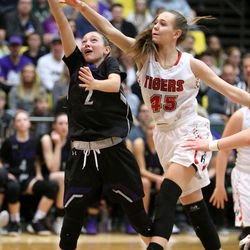Lehi's Macie Warren shoots as Hurricane's Tylee Brisk guards her during the 4A semifinal girls basketball game at the UCCU Center in Orem on Friday, March 2, 2018. Hurricane was trailing most of the game but made a come back to win 43-42 in the last seconds of the game.