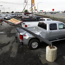 A truck is damaged at the Jerry Seiner dealership in North Salt Lake when a light pole is blown over by the wind, Tuesday, April 9, 2013.