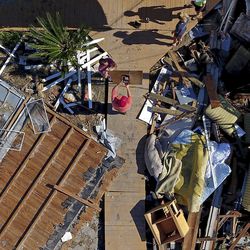 The Wood family begins cleanup efforts among the debris of their damaged home from hurricane Michael in Mexico Beach, Fla., Sunday, Oct. 14, 2018. (AP Photo/David Goldman)