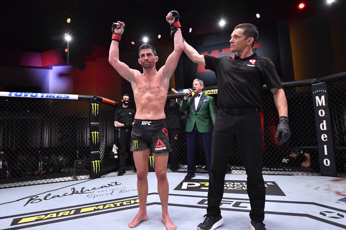 Dominick Cruz gets his hand raised after defeating Casey Kenney at UFC 259.