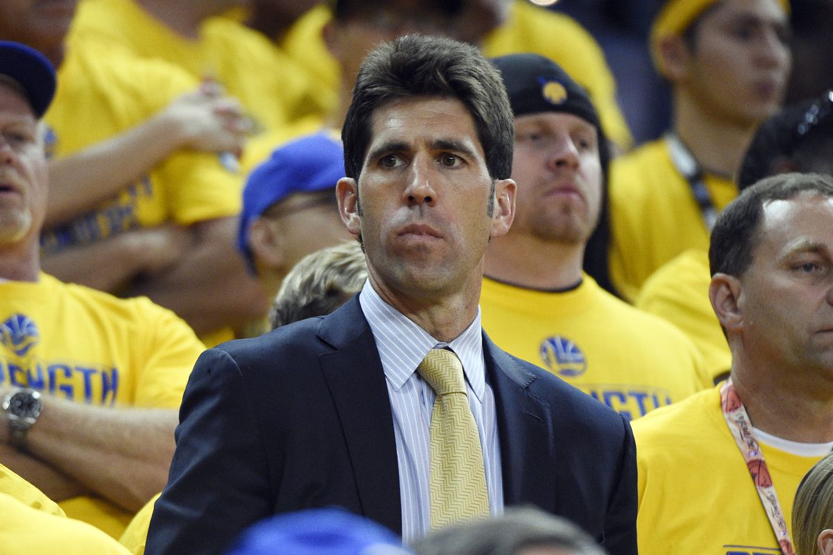 Bob Myers in the stands in front of fans dressed in playoff shirts