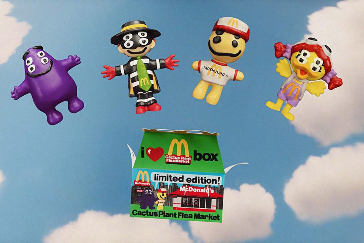 An Image of a Happy Meal box in front of a blue sky. There are four toys floating above the box in the graphic: Grimace, the Hamburglar, and Birdie, and a new friend named Cactus Buddy. They all look like they are made out of clay and have four eyes for some reason.