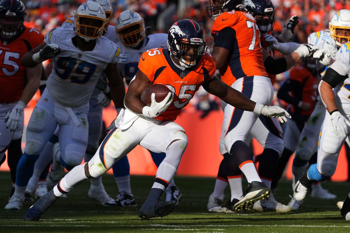 Denver Broncos running back Melvin Gordon (25) carries the ball in the first half against the Los Angeles Chargers at Empower Field at Mile High.