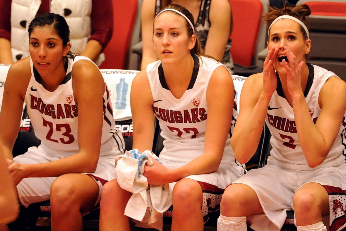 Shalie Dheensaw, Sage Romberg, and Brandi Thomas cheer on their teammates from the bench