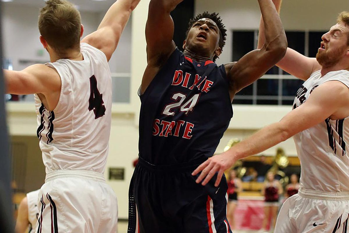 Dixie State junior guard Trevor Hill (center) drives in for two of his season-high 25 points in the Trailblazers’ 104-103 overtime loss at Azusa Pacific on Saturday afternoon.