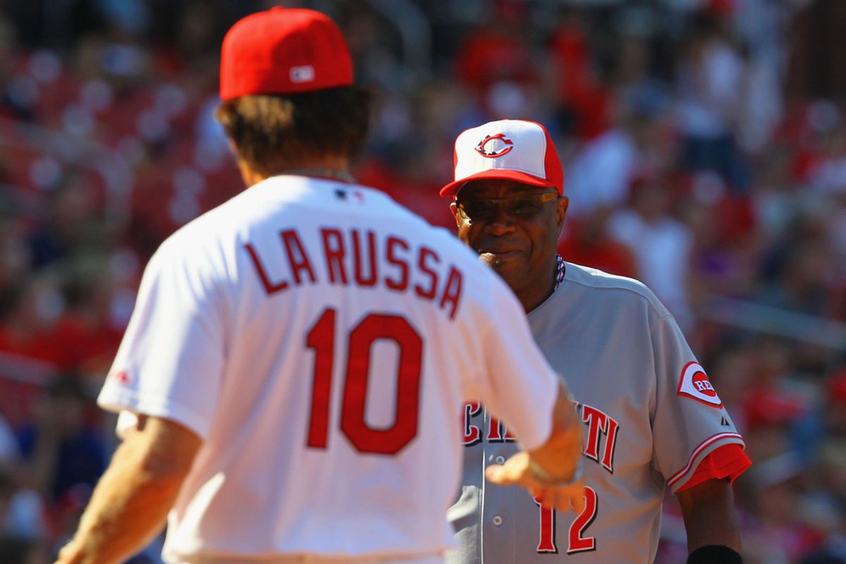 ST. LOUIS, MO - JULY 4: Manger Dusty Baker #12 of the Cincinnati Reds exchanges line-up cards with manager Tony La Russa #10 of the St. Louis Cardinals at Busch Stadium on July 4, 2011 in St. Louis, Missouri.  (Photo by Dilip Vishwanat/Getty Images)