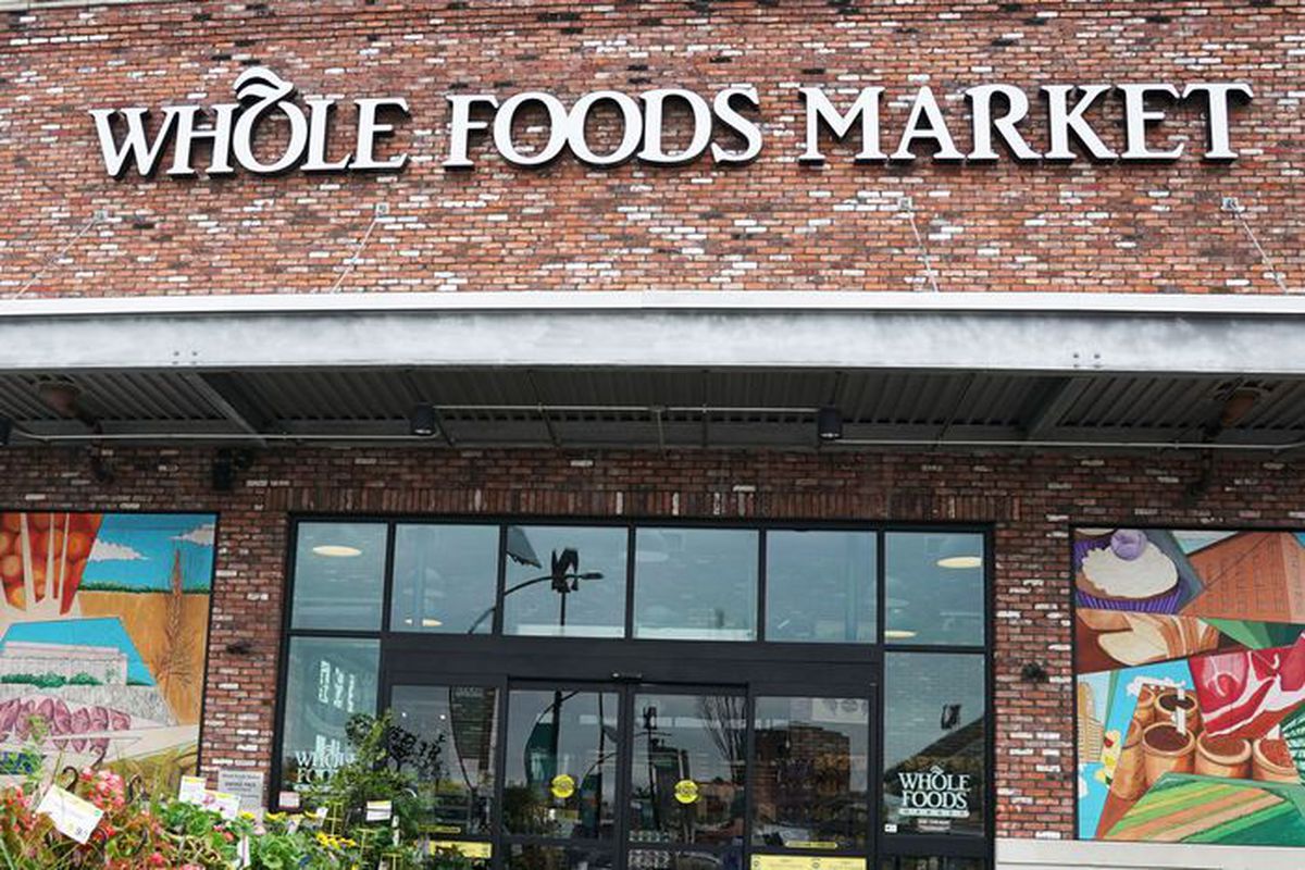 A red brick Whole Foods location with sliding glass doors in front