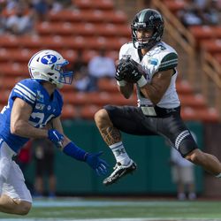 Hawaii wide receiver Jason-Matthew Sharsh (3) catches a pass next to BYU defensive back Austin Kafentzis during the first half of the Hawaii Bowl NCAA college football game Tuesday, Dec. 24, 2019, in Honolulu.