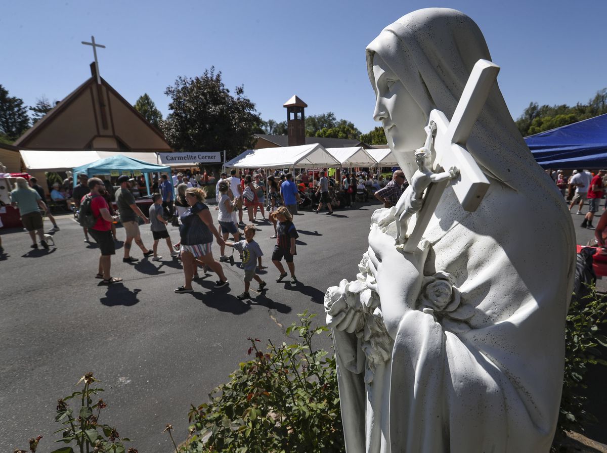 People attend the Carmelite Fair at the Carmelite Monastery in Holladay on Sunday, Sept. 15, 2019. The fair is the main financial support for the monastery and is attended by over 3,000 people each year and includes ethnic foods, music and dancing, games and rides for children, handmade crafts and an auction for donated goods.