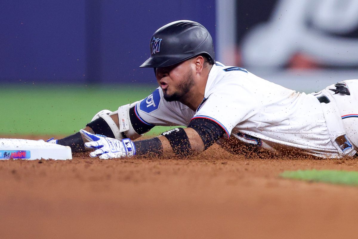 Luis Arraez #3 of the Miami Marlins slides to second base against the Washington Nationals during the eighth inning at loanDepot park on May 17, 2023 in Miami, Florida.