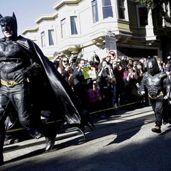 Miles Scott, dressed as Batkid, right, runs with Batman after saving a damsel in distress in San Francisco, Friday, Nov. 15, 2013. San Francisco turned into Gotham City on Friday, as city officials helped fulfill Scott's wish to be "Batkid." Scott, a leukemia patient from Tulelake in far Northern California, was called into service on Friday morning by San Francisco Police Chief Greg Suhr to help fight crime, The Greater Bay Area Make-A-Wish Foundation says.