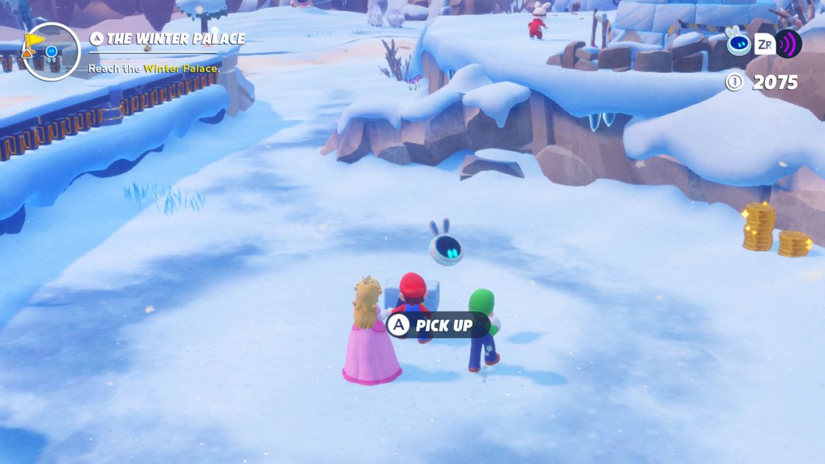 Peach, Mario, and Luigi stand next to the second Igloo brick for the Igloo Breakthrough quest in Mario + Rabbids Sparks of Hope