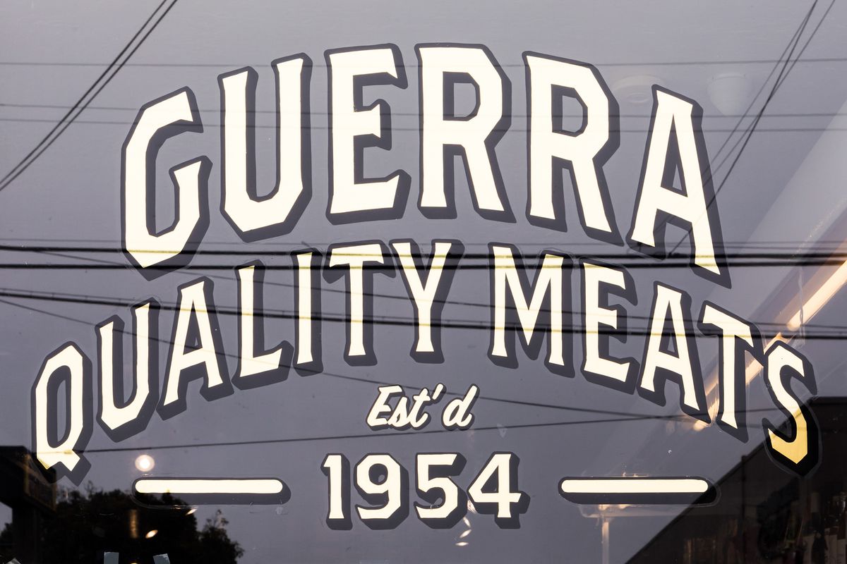 A window that reads “Guerra Quality Meats.”