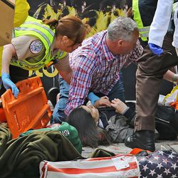 Medical workers aid injured people at the 2013 Boston Marathon following an explosion in Boston, Monday, April 15, 2013. Two explosions shattered the euphoria of the Boston Marathon finish line on Monday, sending authorities out on the course to carry off the injured while the stragglers were rerouted away from the smoking site of the blasts. 