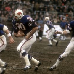 Quarterback Jack Kemp #15 of the Buffalo Bills hands the ball off to Wray Carlton #30 against the Kansas City Chiefs during an AFL football game at War Memorial Stadium December 12, 1965 in Buffalo, New York.