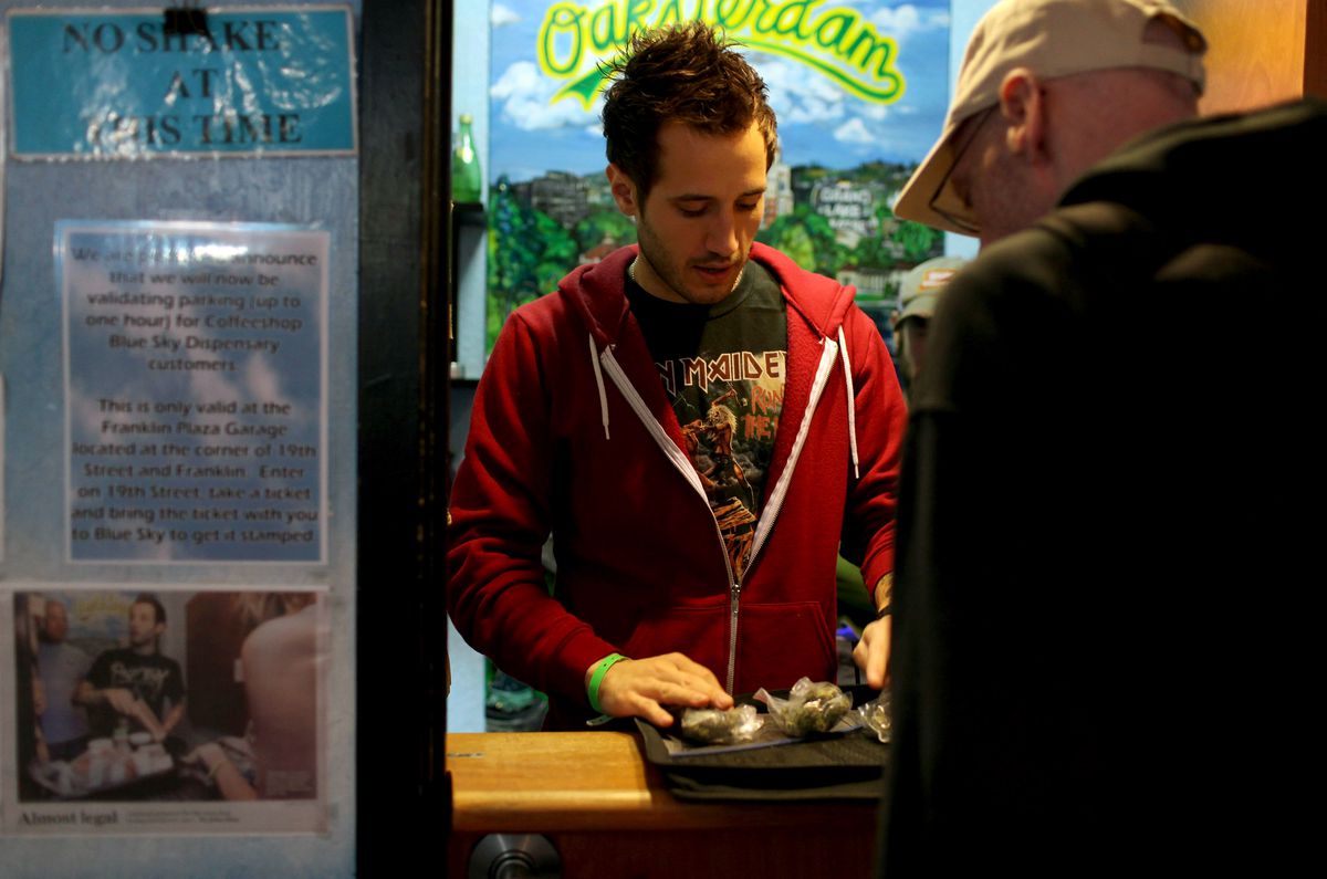A customer looks at different strains of marijuana at a dispensary in Oakland, California.