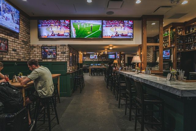 The inside of a sports bar with 22 TVs. 