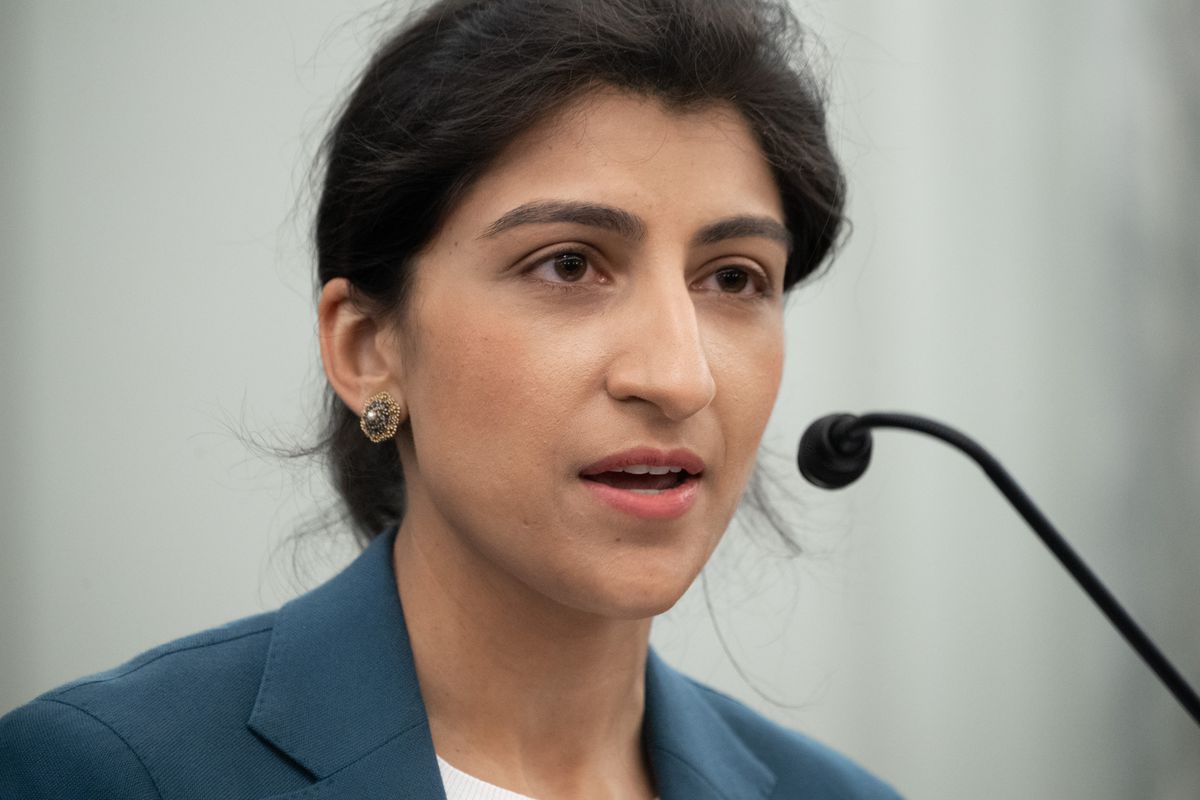 FTC Chair Lina Khan speaking into a microphone.