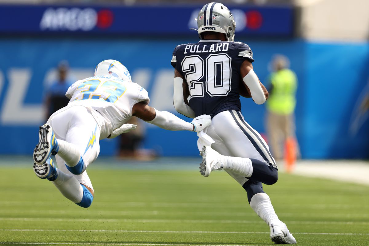 INGLEWOOD, CALIFORNIA - SEPTEMBER 19: Running back Tony Pollard #20 of the Dallas Cowboys runs from a tackle by free safety Derwin James #33 of the Los Angeles Chargers during the first quarter at SoFi Stadium on September 19, 2021 in Inglewood, California.
