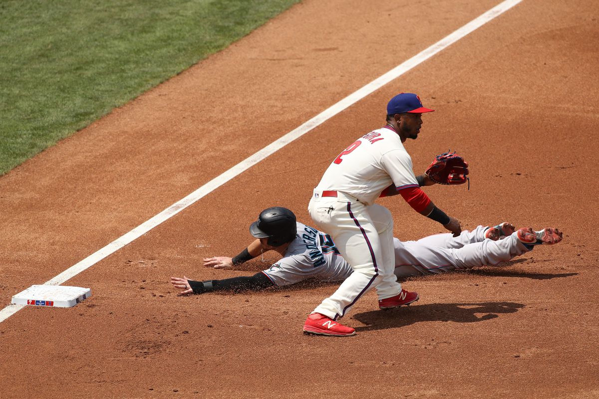 Marlins 3B Brian Anderson (15) slides past Phillies 3B Jean Segura (2) in the third in the second inning during the game between the Miami Marlins and Philadelphia Phillies on July 26, 2020 at Citizens Bank Park in Philadelphia, PA.