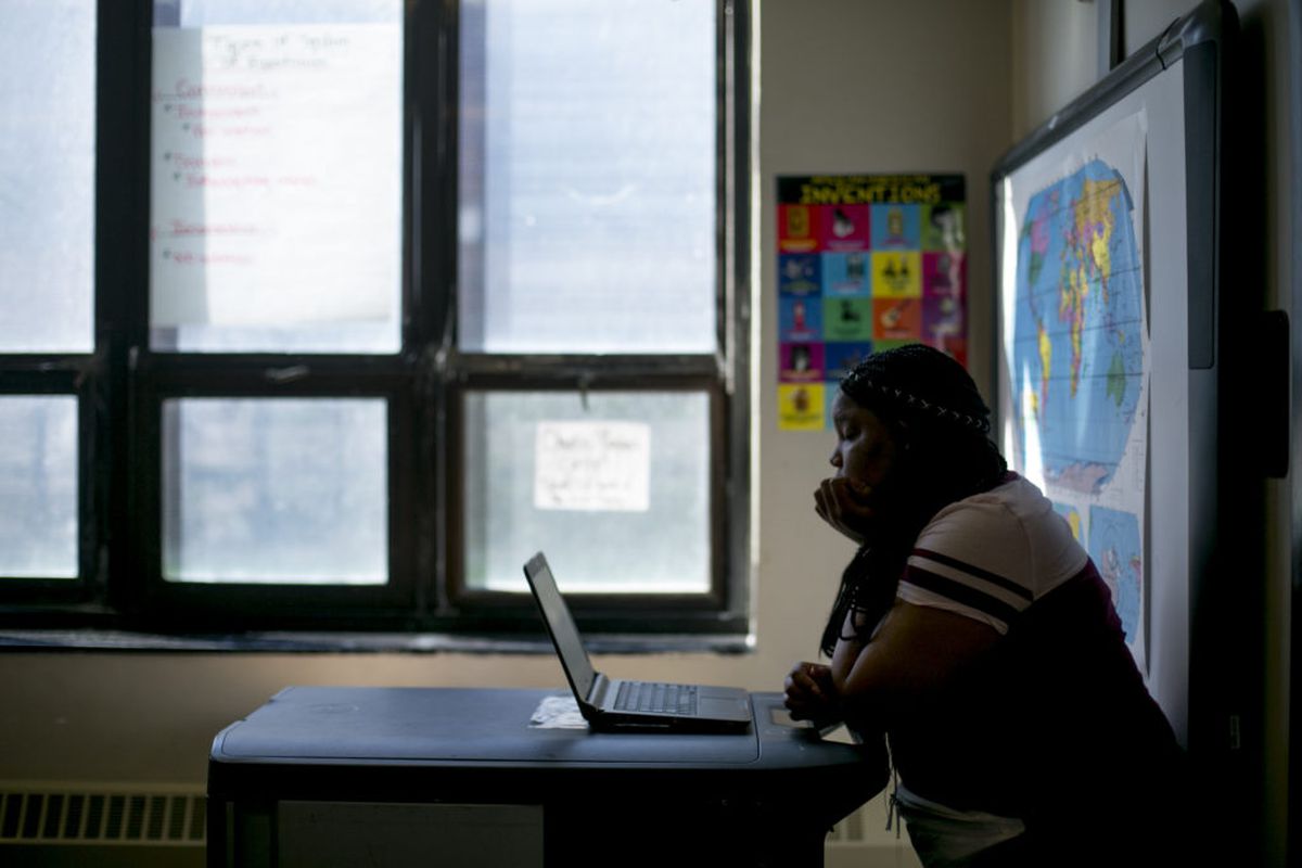 A high school student works on a laptop in a math class at Detroit Public Schools. The district uses Khan Academy to prepare students to take the PSAT and SAT tests.