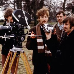 George Harrison, left, John Lennon, an unidentified crew member, and Ringo Starr on the set of the video for "Strawberry Fields Forever."