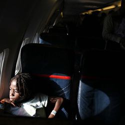 Destine Gordon looks out the window from the aircraft that will transport her and her adoptive father and siblings back to the United States from the airport in Port-au-Prince, Haiti, on Friday, Jan. 29.