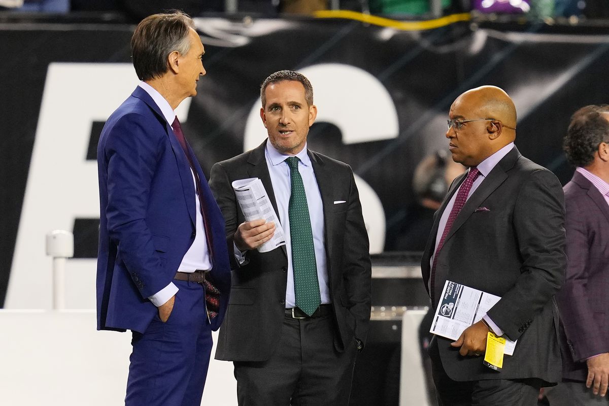 NBC Broadcaster Cris Collinsworth, Philadelphia Eagles General Manager Howie Roseman and NBC Sportscaster Mike Tirico talk on the sidelines prior to the game between the Dallas Cowboys and the Philadelphia Eagles at Lincoln Financial Field on October 16, 2022 in Philadelphia, Pennsylvania.