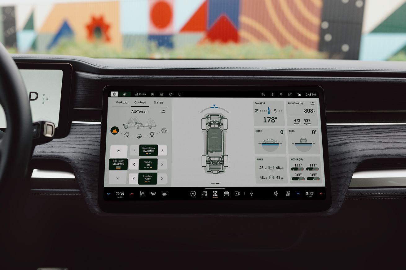 Center screen in a Rivian vehicle showing overhead view and stats.