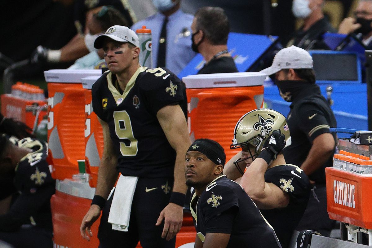 Drew Brees #9 and Jameis Winston #2 of the New Orleans Saints look on from the sideline during their game against the San Francisco 49ers at Mercedes-Benz Superdome on November 15, 2020 in New Orleans, Louisiana.