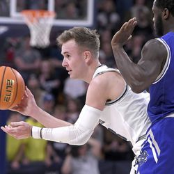 Utah State guard Steven Ashworth, left, looks to pass the ball as New Orleans guard Daniel Sackey (0) defends in the second half of an NCAA college basketball game Saturday, Dec. 11, 2021, in Logan, Utah. 